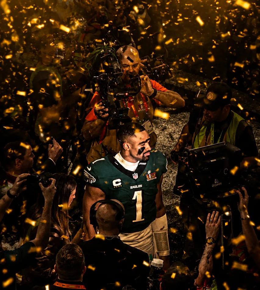 Championship player surrounded by cameras after a win